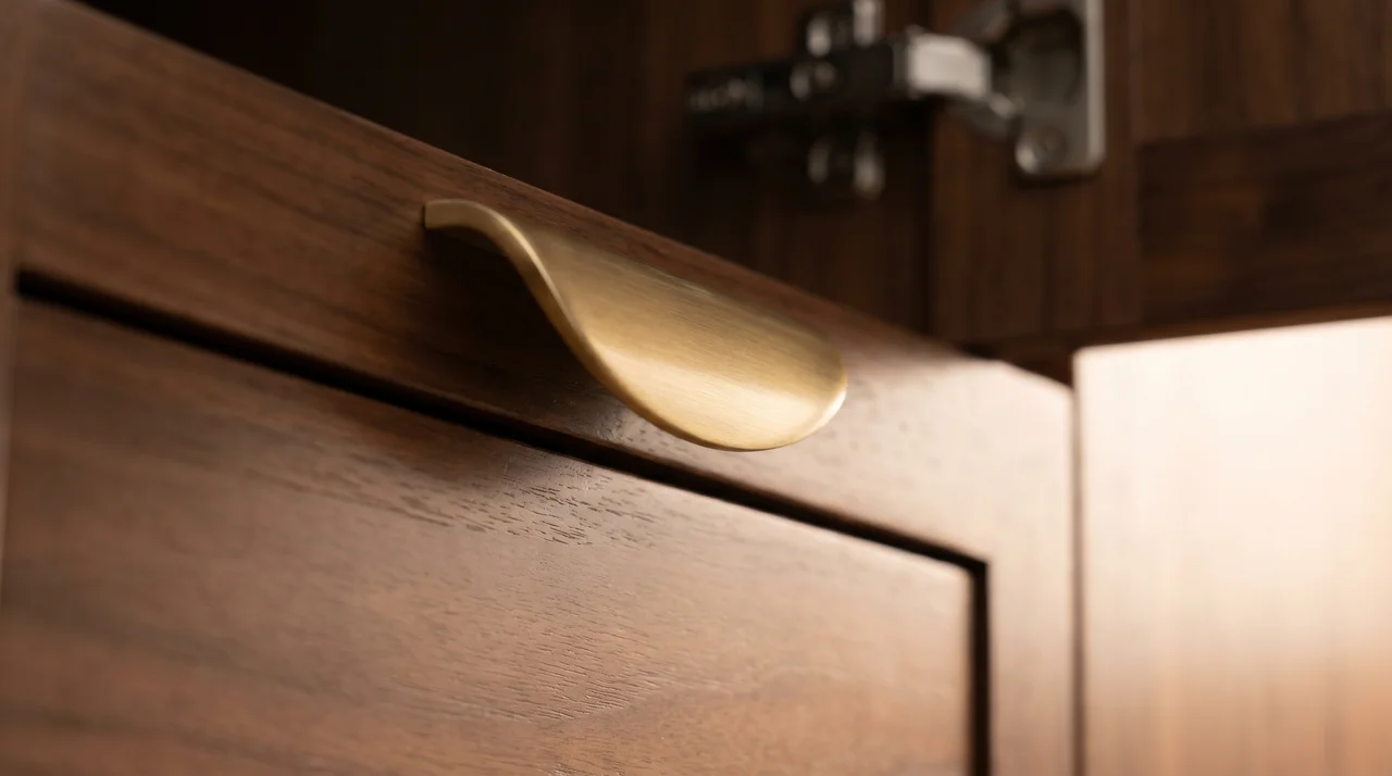 Detail of perfectly aligned cabinet drawers and brass hardware showing meticulous craftsmanship